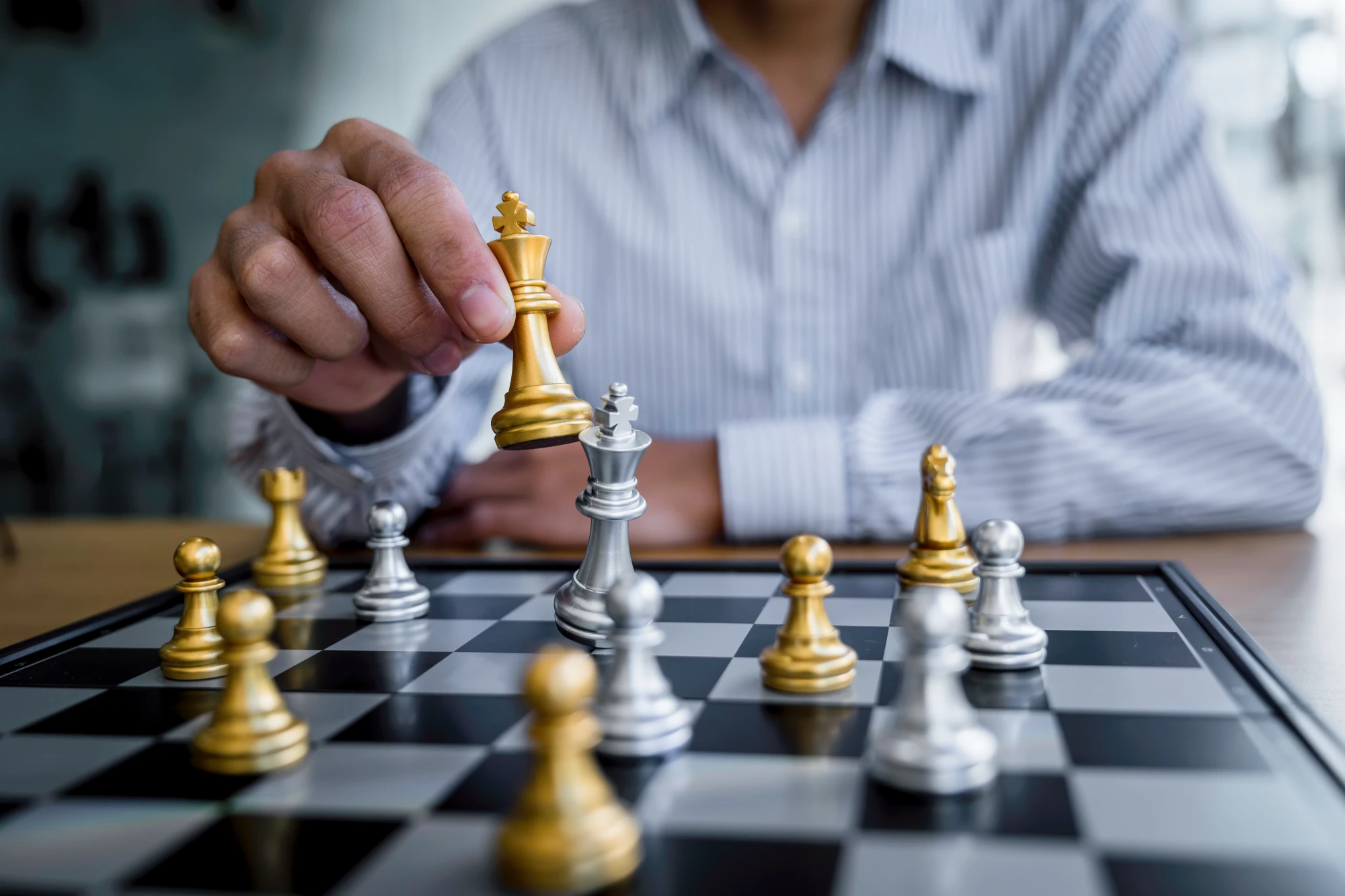 businessman-playing-chess-game-reaching-to-plan